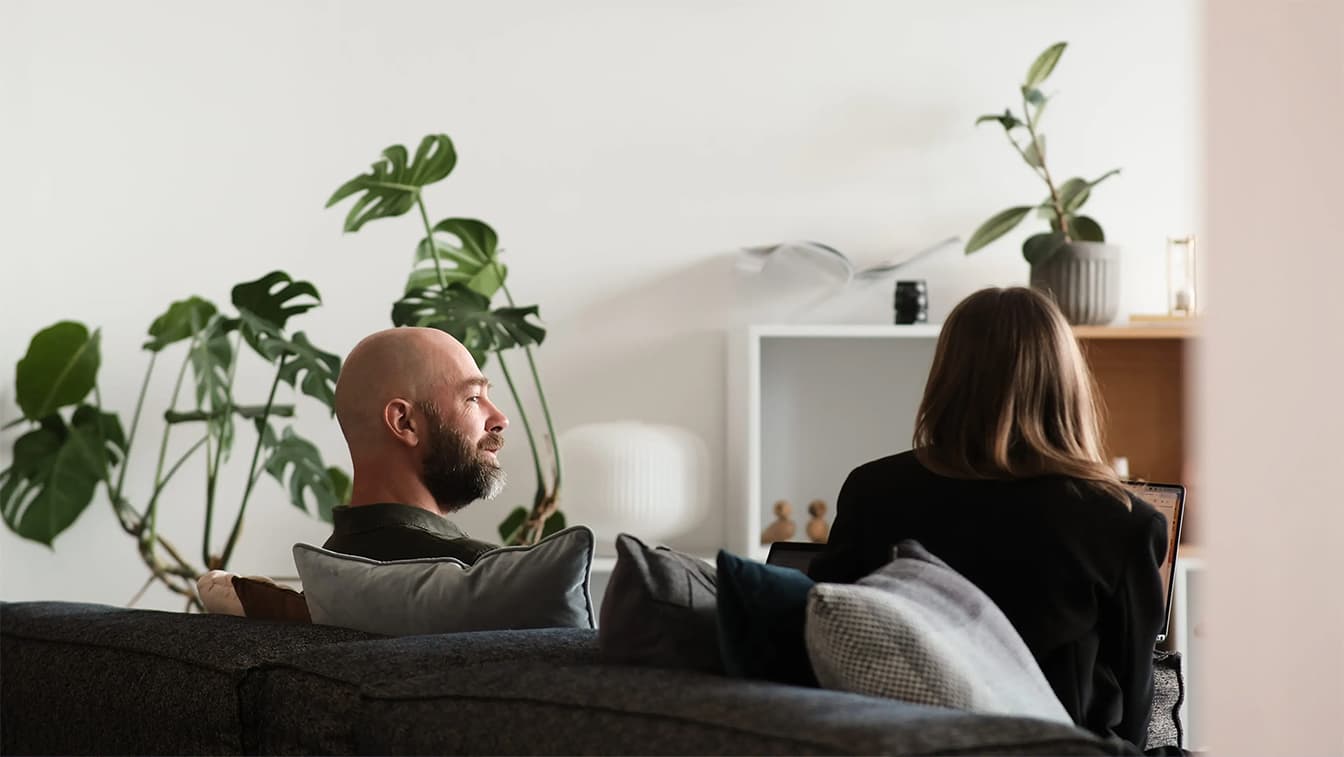 An image of two people sitting in a sofa 